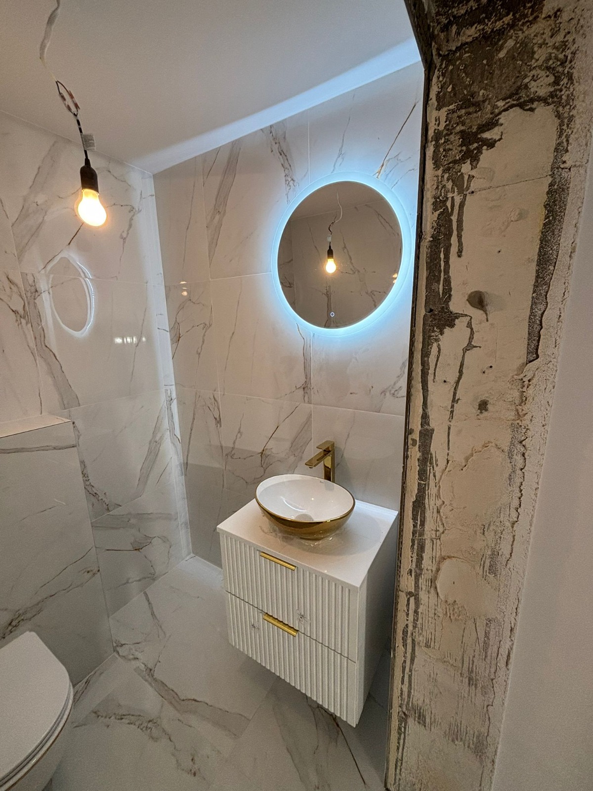 Luxury marble bathroom with gold fixtures