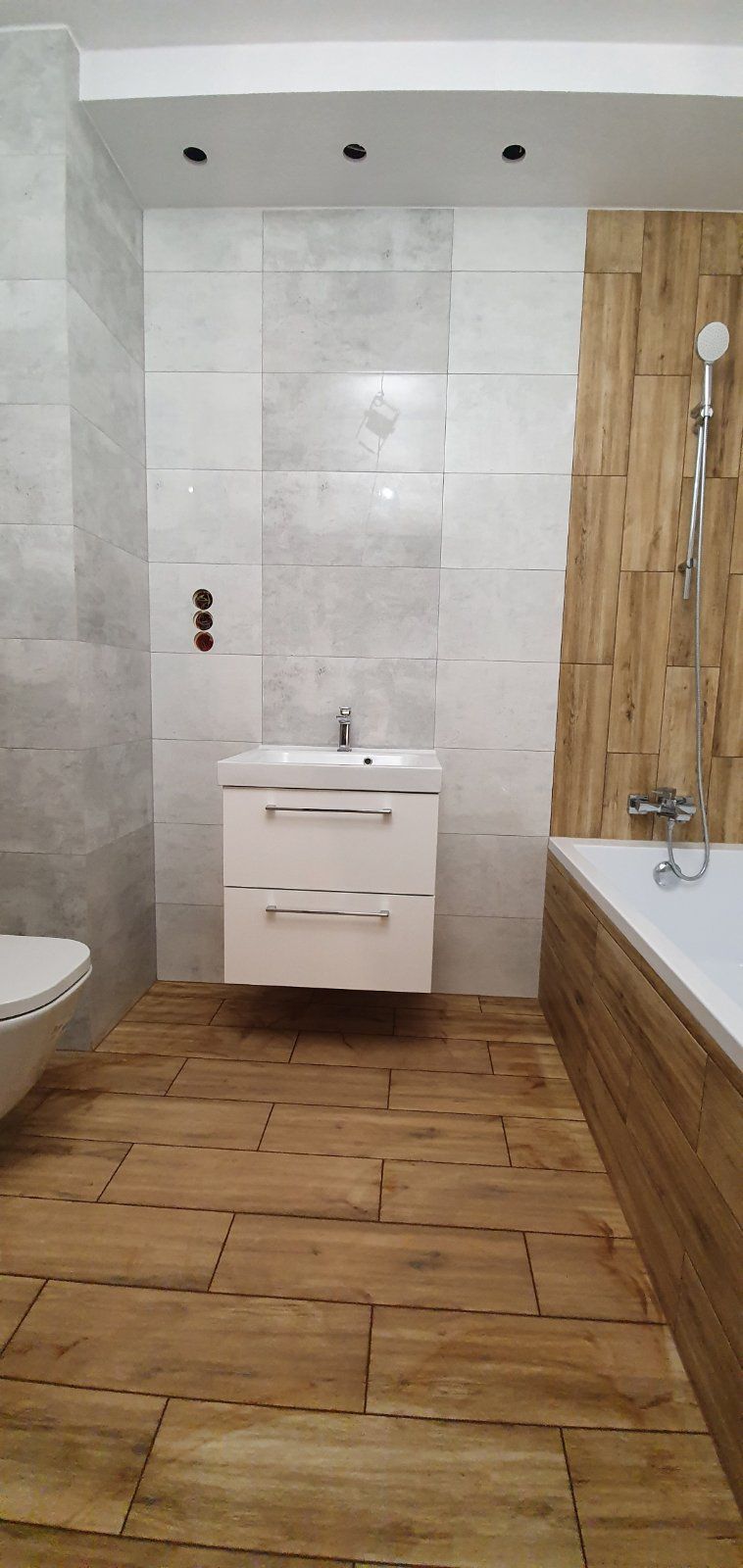 Wood and grey tile bathroom wide view