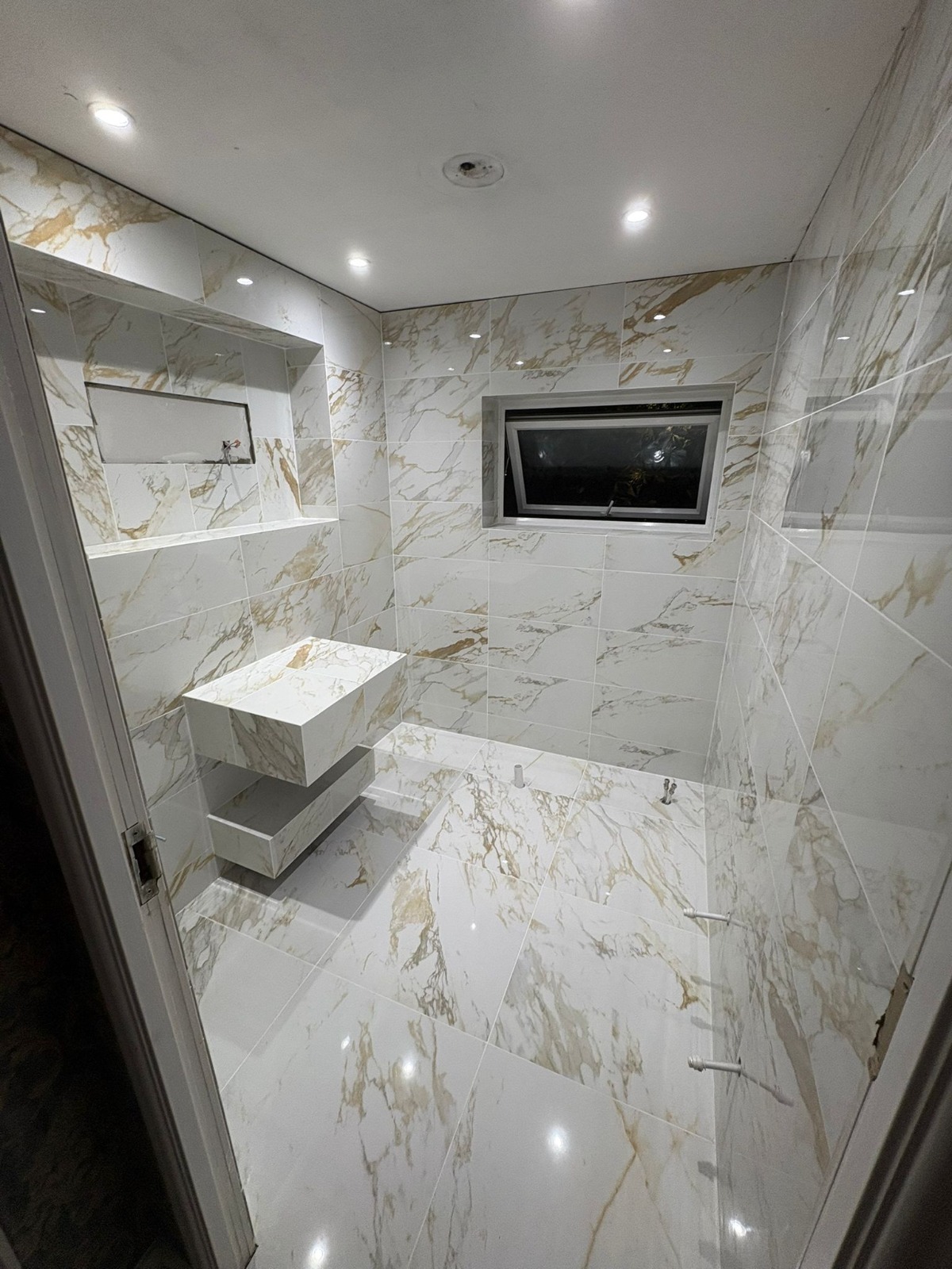 White and gold marble shower room